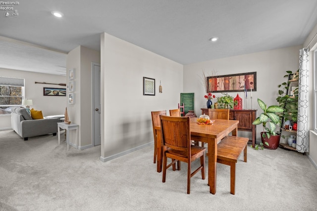 dining room featuring light carpet