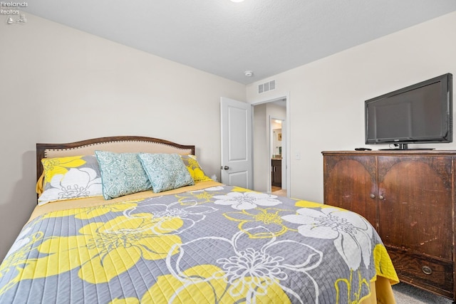 bedroom featuring a textured ceiling and carpet flooring