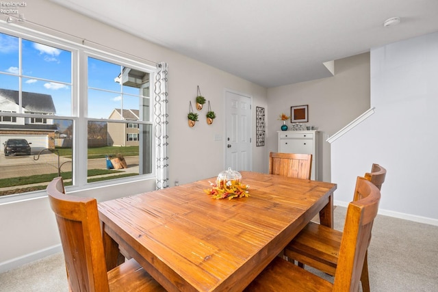 dining area with light colored carpet