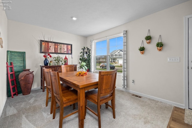 dining room with light carpet