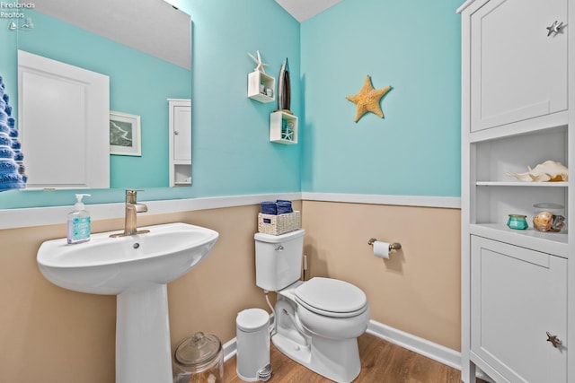 bathroom with hardwood / wood-style floors and toilet