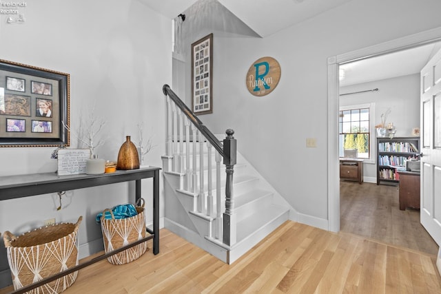 staircase with hardwood / wood-style floors