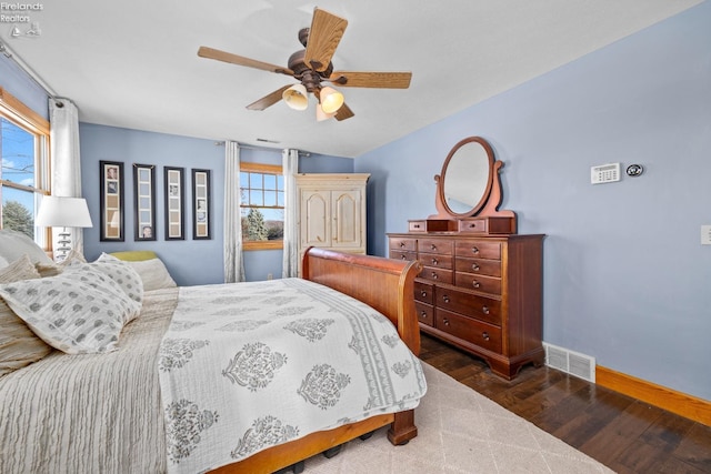 bedroom with ceiling fan and dark hardwood / wood-style flooring