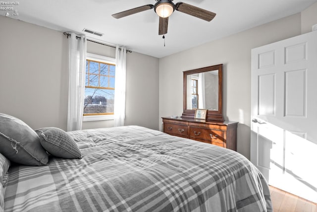 bedroom featuring hardwood / wood-style flooring and ceiling fan