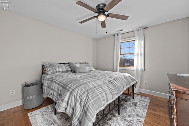 bedroom with dark wood-type flooring and ceiling fan