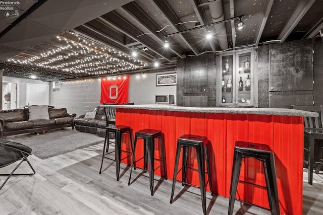 bar with hardwood / wood-style flooring