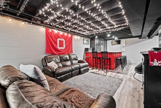 living room with bar and light hardwood / wood-style floors