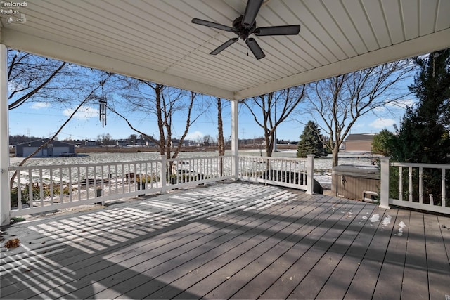 deck with a hot tub and ceiling fan