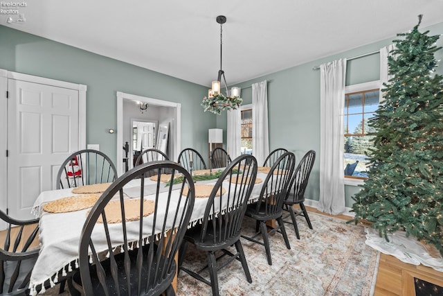 dining room with an inviting chandelier and light hardwood / wood-style flooring