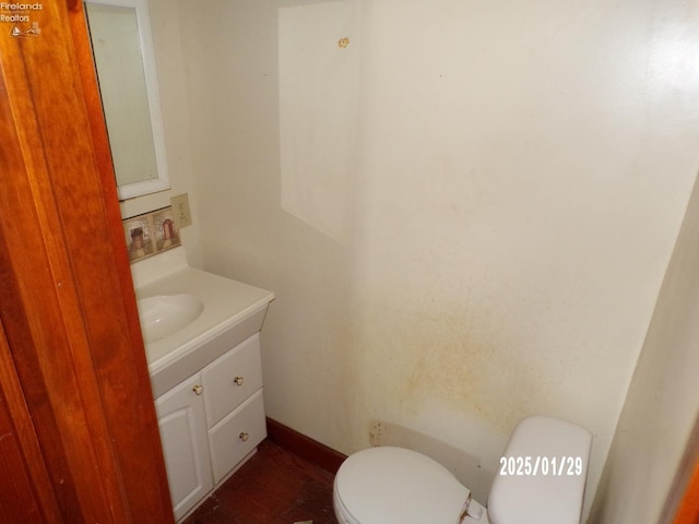 bathroom featuring vanity and toilet