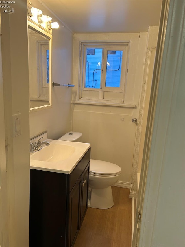 bathroom with vanity, hardwood / wood-style floors, and toilet