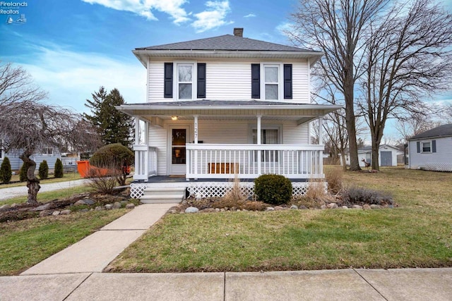 view of front facade featuring covered porch and a front lawn