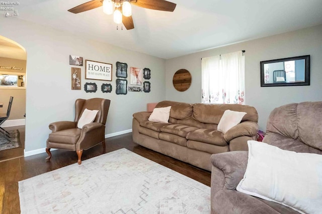 living room with ceiling fan and dark hardwood / wood-style floors