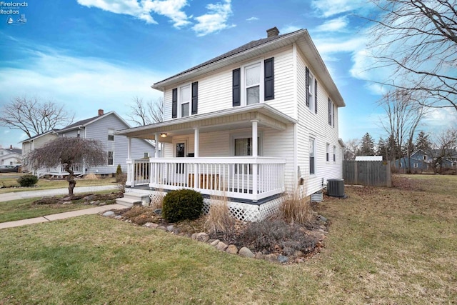 view of front of property with a front yard, covered porch, and cooling unit