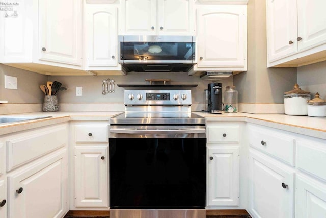 kitchen featuring stainless steel appliances and white cabinets