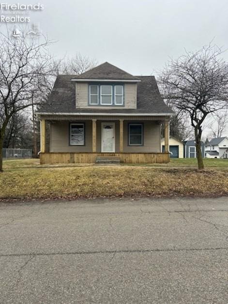 view of front of house with a porch and a front yard