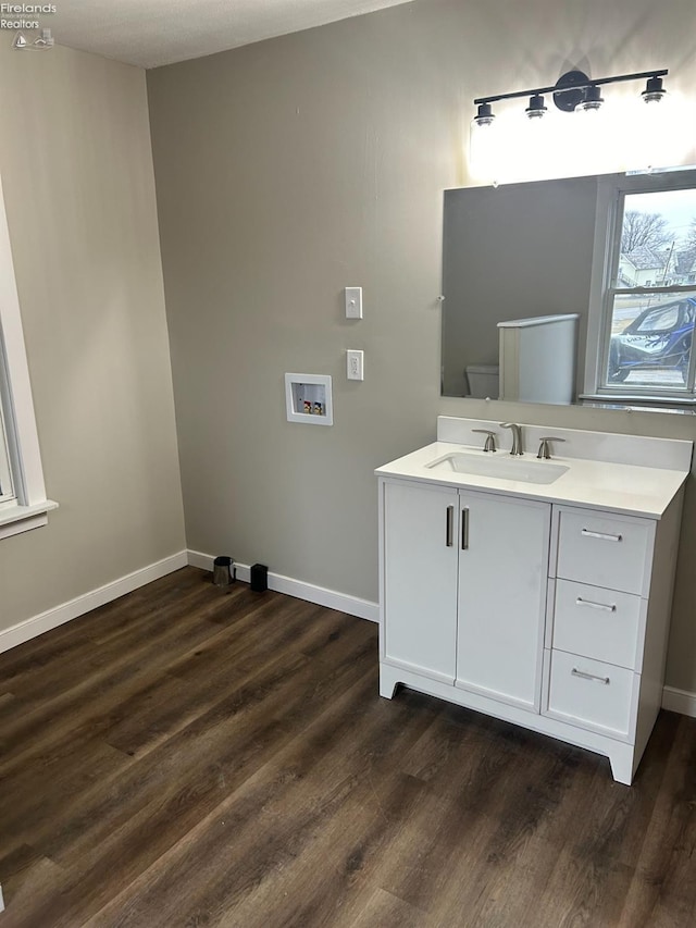 bathroom featuring vanity, hardwood / wood-style flooring, and toilet