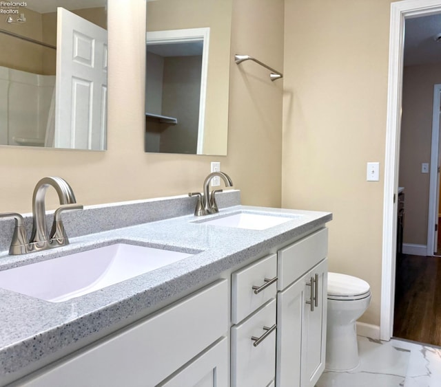 bathroom featuring vanity and toilet