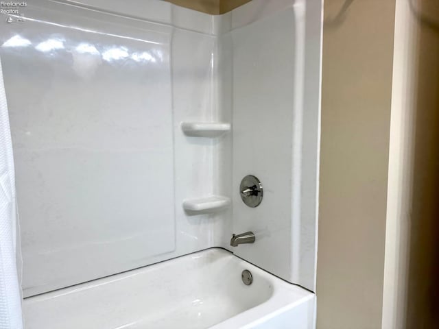 bathroom with shower / bath combination with curtain