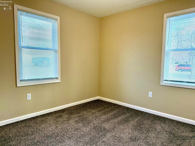 carpeted empty room featuring plenty of natural light