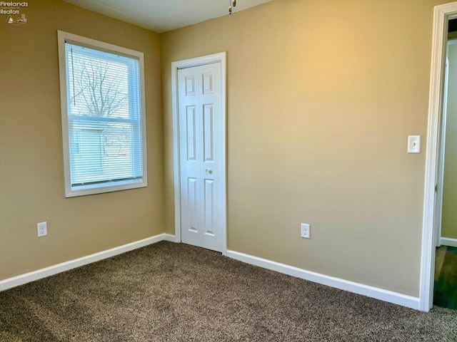 unfurnished bedroom featuring carpet flooring and a closet