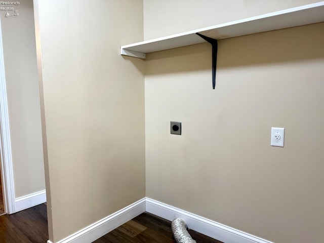 clothes washing area featuring electric dryer hookup and dark wood-type flooring