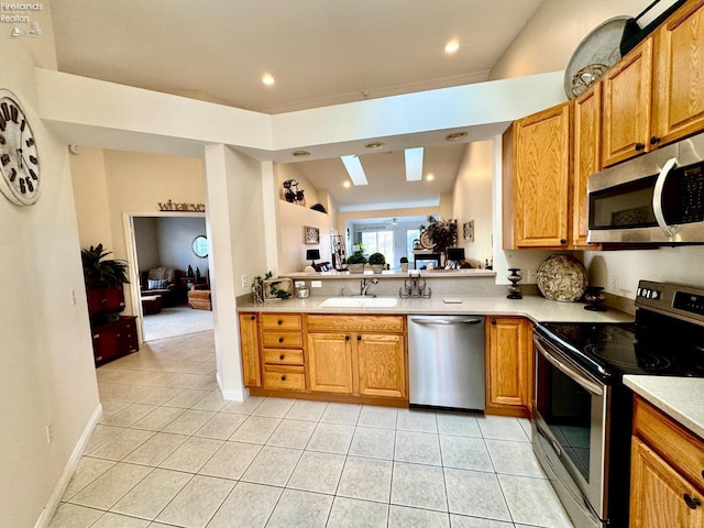 kitchen featuring appliances with stainless steel finishes, sink, and light tile patterned floors