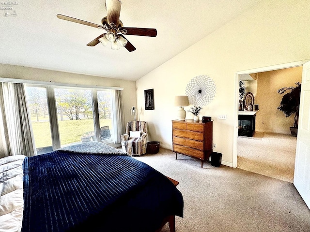 carpeted bedroom with access to outside, ceiling fan, and vaulted ceiling