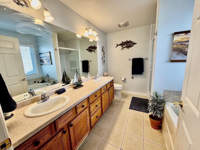 full bathroom with plus walk in shower, tile patterned flooring, vanity, toilet, and a textured ceiling