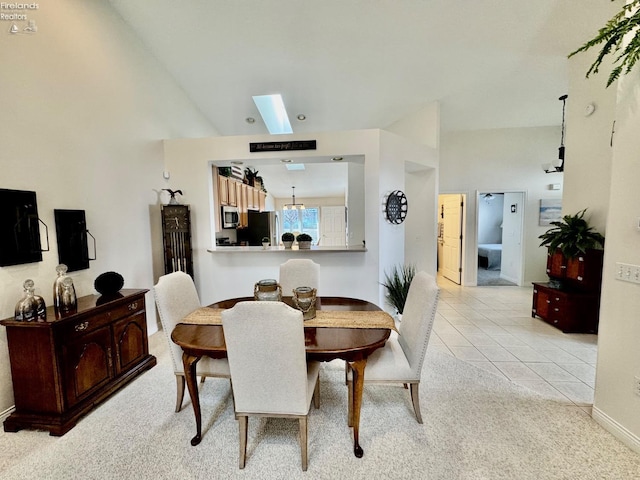 tiled dining space featuring lofted ceiling