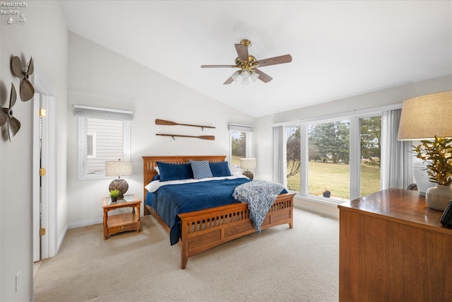 bedroom featuring ceiling fan, light colored carpet, and vaulted ceiling