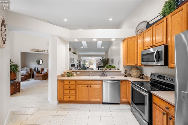 kitchen featuring light tile patterned flooring, appliances with stainless steel finishes, and sink