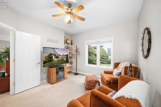 carpeted living room featuring ceiling fan