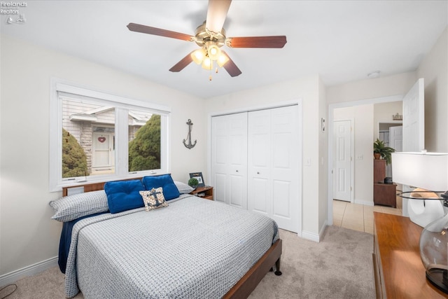 carpeted bedroom with ceiling fan and a closet