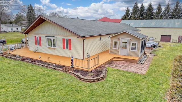 back of house with a wooden deck and a yard