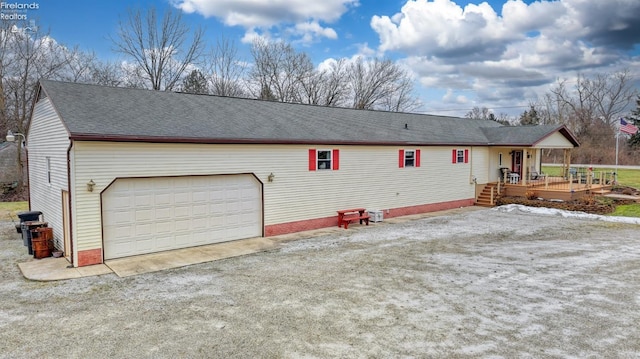 view of home's exterior with a garage and a porch