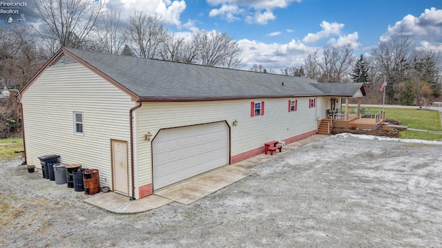 view of home's exterior featuring a garage and a deck