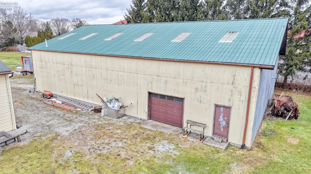 view of outbuilding with a yard and a garage