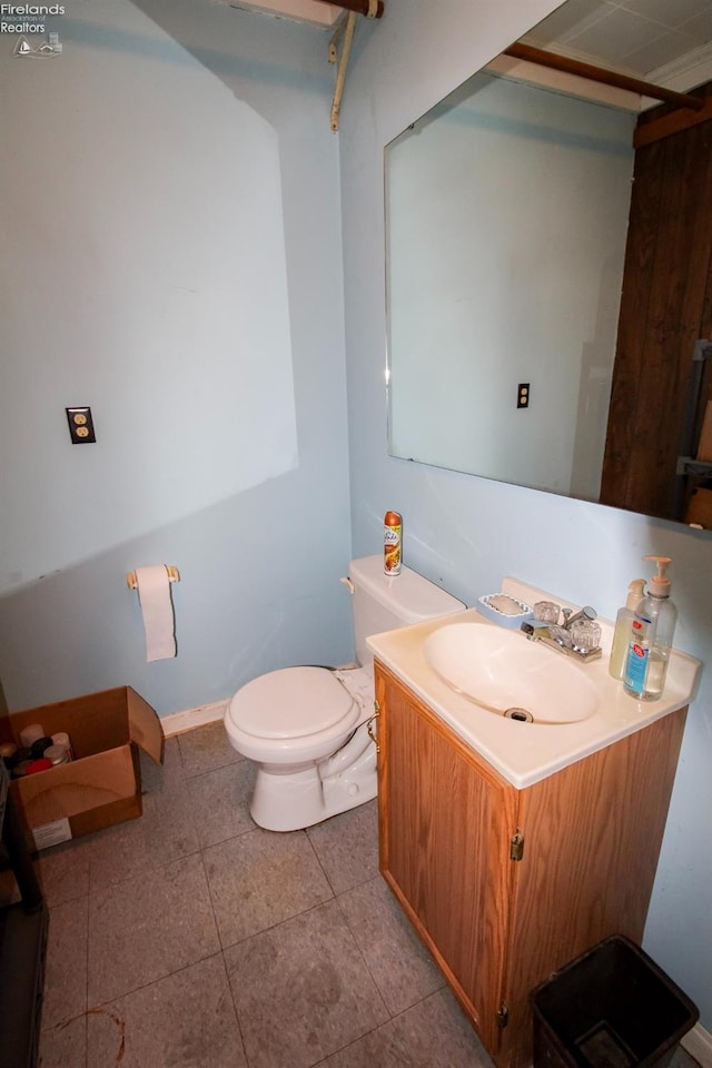 bathroom with vanity, tile patterned floors, and toilet