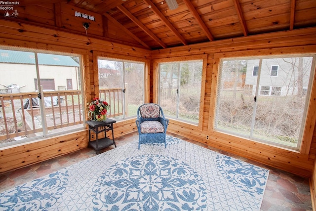 sunroom / solarium featuring lofted ceiling with beams and wooden ceiling