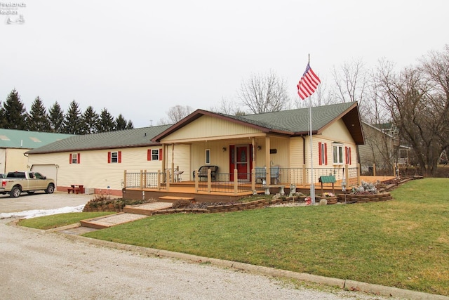 ranch-style house with a garage, a front lawn, and a porch