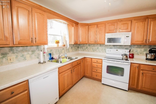 kitchen with sink, white appliances, and decorative backsplash