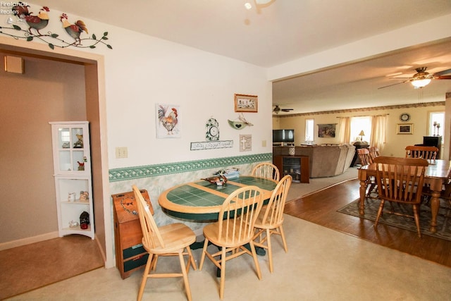 dining room with hardwood / wood-style flooring and ceiling fan