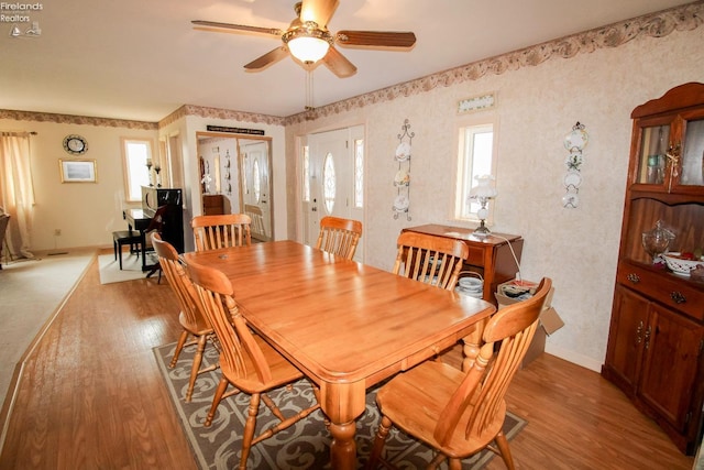 dining room with ceiling fan and light hardwood / wood-style floors