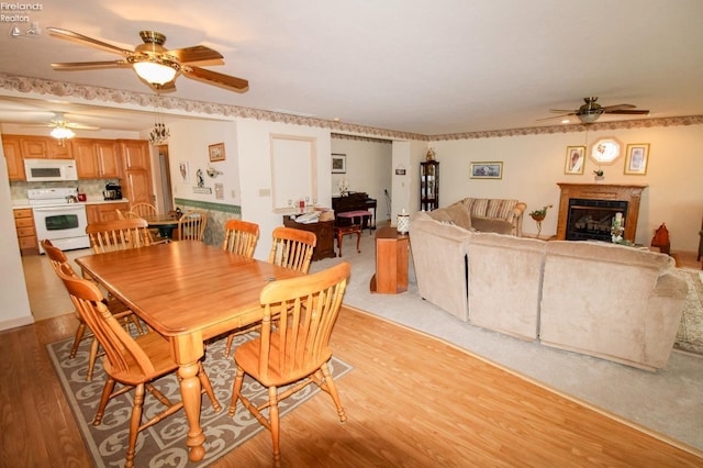 dining area featuring ceiling fan and light hardwood / wood-style flooring