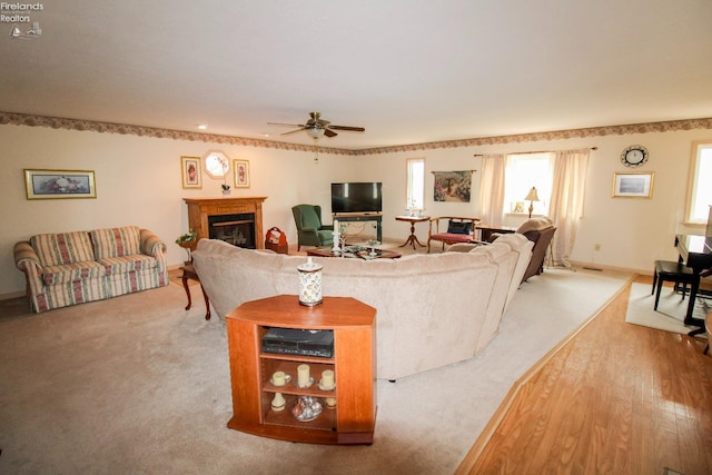 living room with light carpet and ceiling fan