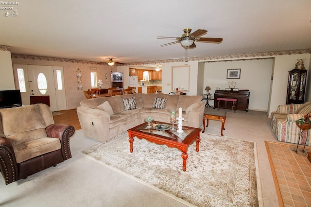 living room with ceiling fan and light colored carpet