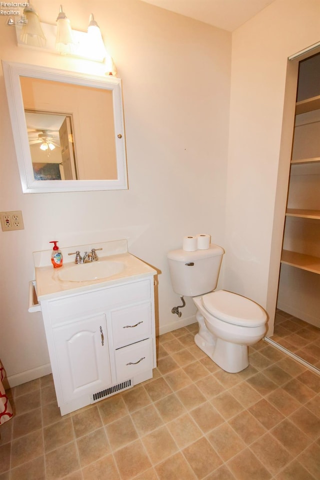 bathroom featuring vanity, tile patterned floors, and toilet