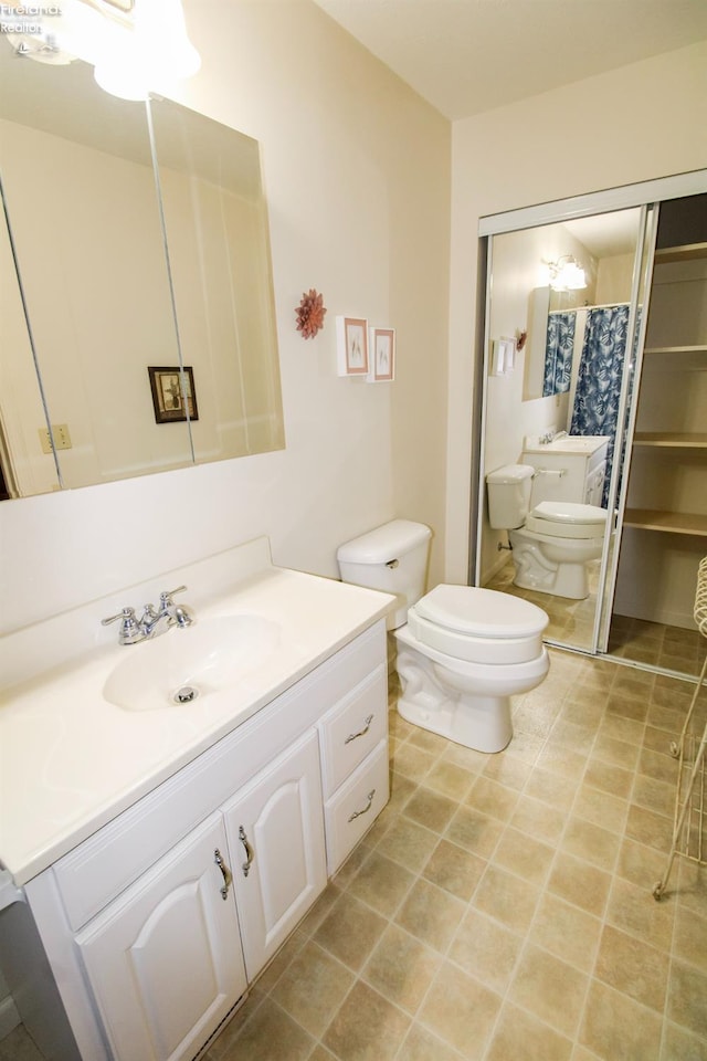 bathroom with a shower with curtain, vanity, tile patterned flooring, and toilet