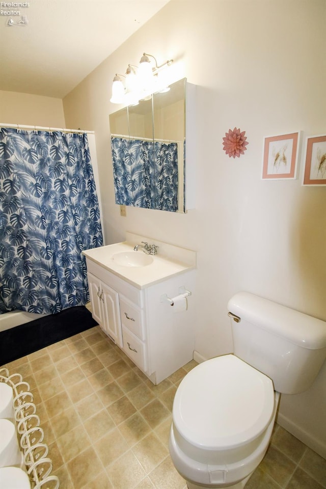 bathroom with walk in shower, tile patterned floors, vanity, and toilet